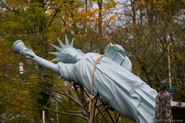 freedom to pollute with bronze statue of refugee